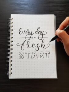 every day is a fresh start calligraphy on a notepad